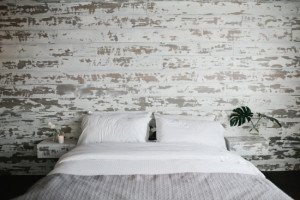 A paneled wall is a great backdrop to a simple bed.