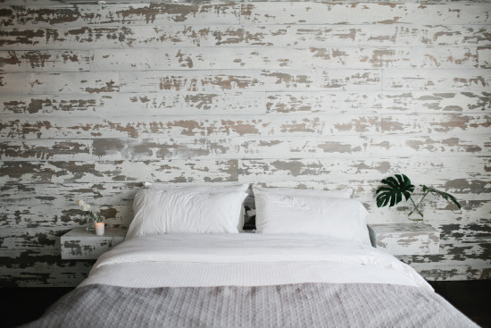 A paneled wall is a great backdrop to a simple bed.