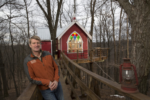 Nelson, owner of Nelson Treehouse and Supply, poses by a Ohio brewery 