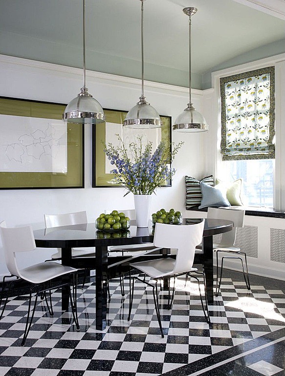 Black and white tiled flooring is a modern addition to this kitchen designed by Jessica Lagrange Interiors. 