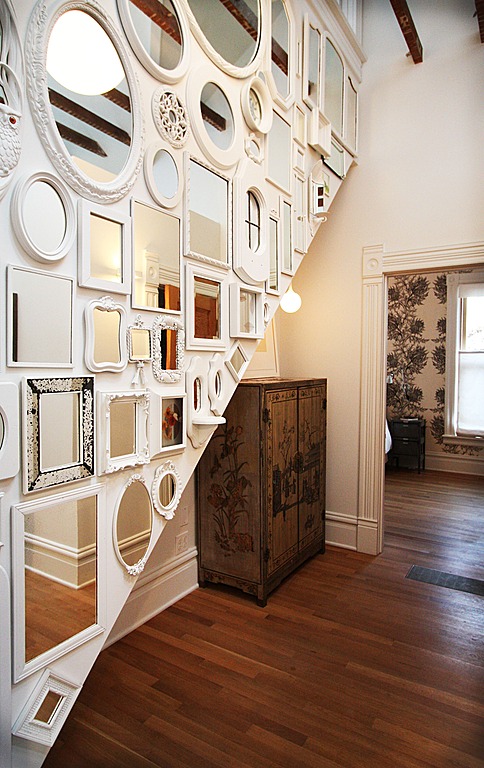 A varied gallery of mirrors is a great addition to this entry way design by bright designlab interior design.
