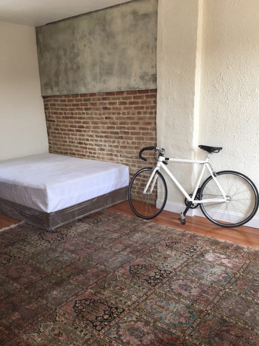 Room enough for a bed and a bike to get to campaign headquarters.