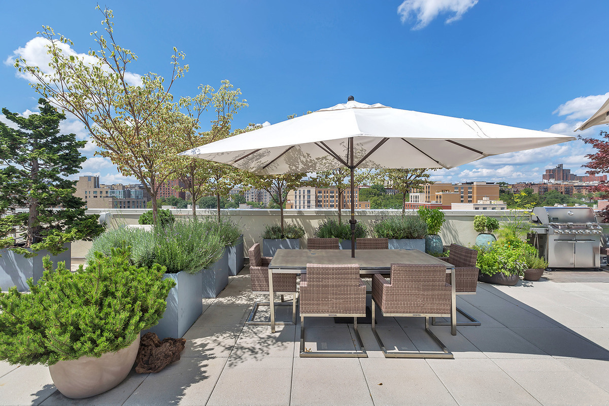 The terrace features custom landscaping, two seating areas, and even a sound system.